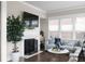 Cozy living room with fireplace, large windows, and stylish decor for relaxation at 4800 Gablestone Xing, Hoschton, GA 30548
