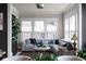 Beautiful living room with a gray sectional couch, recessed lighting, and large windows at 4800 Gablestone Xing, Hoschton, GA 30548