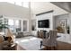 Bright and airy living room with a soaring ceiling, fireplace, and comfortable seating at 4800 Gablestone Xing, Hoschton, GA 30548