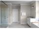 Spacious bathroom featuring glass shower, soaking tub, single vanity, and tiled floor at 4800 Gablestone Xing, Hoschton, GA 30548