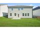 Spacious backyard with green lawn, patio, and fenced perimeter, perfect for outdoor activities and relaxation at 7161 Gladstone Cir, Lithonia, GA 30038