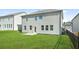 View of the home's backyard and adjacent building featuring a well-maintained lawn and neutral siding at 7161 Gladstone Cir, Lithonia, GA 30038