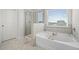 Bathroom featuring a soaking tub, separate shower, and tiled floors at 7161 Gladstone Cir, Lithonia, GA 30038
