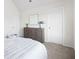 Bright bedroom with a gray dresser, neutral decor, and a comfortable-looking bed with white textured comforter at 7161 Gladstone Cir, Lithonia, GA 30038