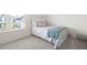 Cozy bedroom featuring a window with blinds, a comfortable bed, and neutral-toned decor, creating a serene atmosphere at 7161 Gladstone Cir, Lithonia, GA 30038