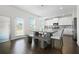 Bright dining area with a modern table set and access to the backyard at 7161 Gladstone Cir, Lithonia, GA 30038