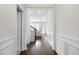 Bright hallway with decorative wall trim and dark wood flooring that leads to the living area at 7161 Gladstone Cir, Lithonia, GA 30038