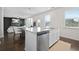 Open floor plan featuring kitchen island with sink and stainless steel dishwasher at 7161 Gladstone Cir, Lithonia, GA 30038