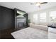 Comfortable living room featuring a modern fireplace and a large white rug at 7161 Gladstone Cir, Lithonia, GA 30038