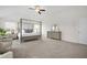 Bright main bedroom featuring a four-poster bed, soft carpet, and ample natural light at 7161 Gladstone Cir, Lithonia, GA 30038