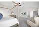 Spacious main bedroom with a four-poster bed, sitting area, and neutral color scheme at 7161 Gladstone Cir, Lithonia, GA 30038