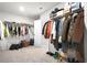 Large walk-in closet with abundant storage, clothing racks, and carpet flooring at 7161 Gladstone Cir, Lithonia, GA 30038
