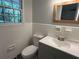 Updated bathroom with white tile, gray vanity, modern mirror, and patterned floors at 779 Casplan Sw St, Atlanta, GA 30310