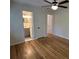 Bedroom with gleaming hardwood floors, neutral walls, and view into en-suite bathroom at 779 Casplan Sw St, Atlanta, GA 30310