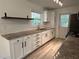 Bright kitchen featuring new white cabinets, granite countertops and subway tile backsplash at 779 Casplan Sw St, Atlanta, GA 30310