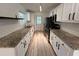 Fully renovated kitchen with granite counters, stainless appliances, and a bright, clean design at 779 Casplan Sw St, Atlanta, GA 30310