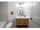 Bathroom featuring a wooden vanity, modern mirror, and a tiled shower and tub at 830 Lee Nw Dr, Marietta, GA 30060