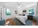 Cozy bedroom features hardwood floors, a ceiling fan, and natural light from two windows at 830 Lee Nw Dr, Marietta, GA 30060