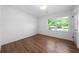 Bright bedroom with hardwood floors, white walls, and a large window at 830 Lee Nw Dr, Marietta, GA 30060