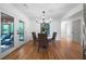 Dining area featuring hardwood floors, modern light fixture, and view of screened deck at 830 Lee Nw Dr, Marietta, GA 30060