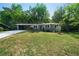 Charming single-story home featuring a long driveway, carport, and well-maintained front lawn at 830 Lee Nw Dr, Marietta, GA 30060