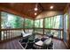 Inviting screened-in porch with wood ceilings, ample seating, and views of the surrounding trees at 830 Lee Nw Dr, Marietta, GA 30060