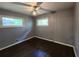 Cozy bedroom with two windows letting in ample natural light, and dark hardwood flooring at 1321 Snapfinger Rd, Decatur, GA 30032