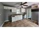 Compact kitchen with tile floors, stainless steel appliances, and light cabinetry at 1321 Snapfinger Rd, Decatur, GA 30032
