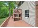 A multi-tiered wood deck offers ample space for outdoor relaxation, overlooking landscaped grounds and mature trees at 2650 Wendell Creek Ln, Snellville, GA 30039