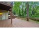 A large, stained back deck with wooden railings and access to an external staircase leading to upper floor at 2650 Wendell Creek Ln, Snellville, GA 30039