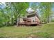 Exterior of house featuring large back deck and patio, nestled among lush greenery, offering serene views at 2650 Wendell Creek Ln, Snellville, GA 30039
