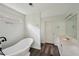 This bathroom features a freestanding tub and a single sink vanity at 2650 Wendell Creek Ln, Snellville, GA 30039