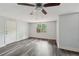 Well-lit bedroom featuring updated flooring and windows with views of the outdoors at 2650 Wendell Creek Ln, Snellville, GA 30039