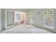 Bedroom with carpet, natural light from windows, and adjacent rooms with french doors at 2650 Wendell Creek Ln, Snellville, GA 30039