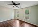This bedroom features hardwood floors, neutral colored walls, and two windows overlooking the yard at 2650 Wendell Creek Ln, Snellville, GA 30039