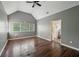 This bedroom has a vaulted ceiling, multiple windows, and wood flooring at 2650 Wendell Creek Ln, Snellville, GA 30039