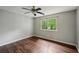 Cozy bedroom featuring hardwood floors, a ceiling fan, and a window at 2650 Wendell Creek Ln, Snellville, GA 30039