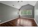 This bedroom has a vaulted ceiling, multiple windows, and wood flooring at 2650 Wendell Creek Ln, Snellville, GA 30039