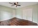 This bedroom includes wood floors, a ceiling fan, and a closet with folding doors at 2650 Wendell Creek Ln, Snellville, GA 30039