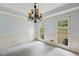 Elegant dining room with carpet, chandelier, natural light from windows, and white trim at 2650 Wendell Creek Ln, Snellville, GA 30039