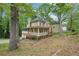 Traditional home showcasing a wrap-around porch and lush greenery at 2650 Wendell Creek Ln, Snellville, GA 30039