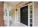 Classic front porch with a black front door and brick accents providing a welcoming entrance at 2650 Wendell Creek Ln, Snellville, GA 30039