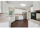 Charming kitchen featuring stainless steel appliances, white cabinets, and dark wood flooring at 2650 Wendell Creek Ln, Snellville, GA 30039