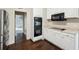 Charming kitchen featuring stainless steel appliances, white cabinets, and dark wood flooring at 2650 Wendell Creek Ln, Snellville, GA 30039