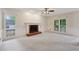 Spacious living room with a fireplace, wainscoting, and large windows at 2650 Wendell Creek Ln, Snellville, GA 30039