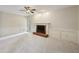 Bright living room with neutral carpet, white trim, brick fireplace, and ceiling fan at 2650 Wendell Creek Ln, Snellville, GA 30039