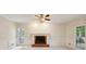 Bright living room featuring neutral carpet, fireplace, white trim, and natural light from windows at 2650 Wendell Creek Ln, Snellville, GA 30039