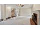 Open-concept living room featuring a fireplace, neutral paint, and connecting spaces at 2650 Wendell Creek Ln, Snellville, GA 30039
