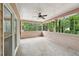 Relaxing screened porch with a ceiling fan, offering views of the surrounding greenery at 2650 Wendell Creek Ln, Snellville, GA 30039