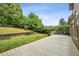 A spacious wooden deck overlooks a lush, green backyard with a tiered garden and mature trees providing privacy at 2656 White Rock Dr, Buford, GA 30519
